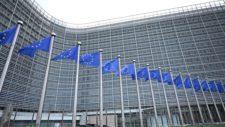 European Union flags flying outside the European Commission's Berlaymont headquarters in Brussels.
